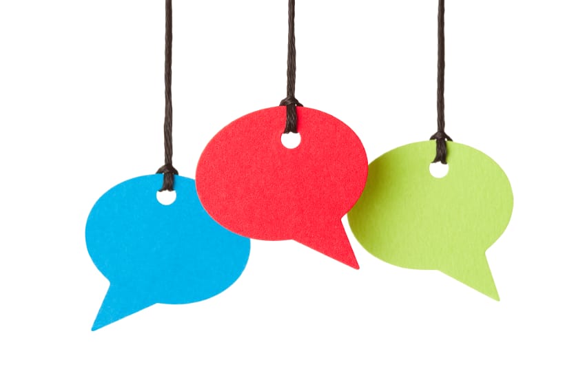 Three blank speech bubbles hanging from thread